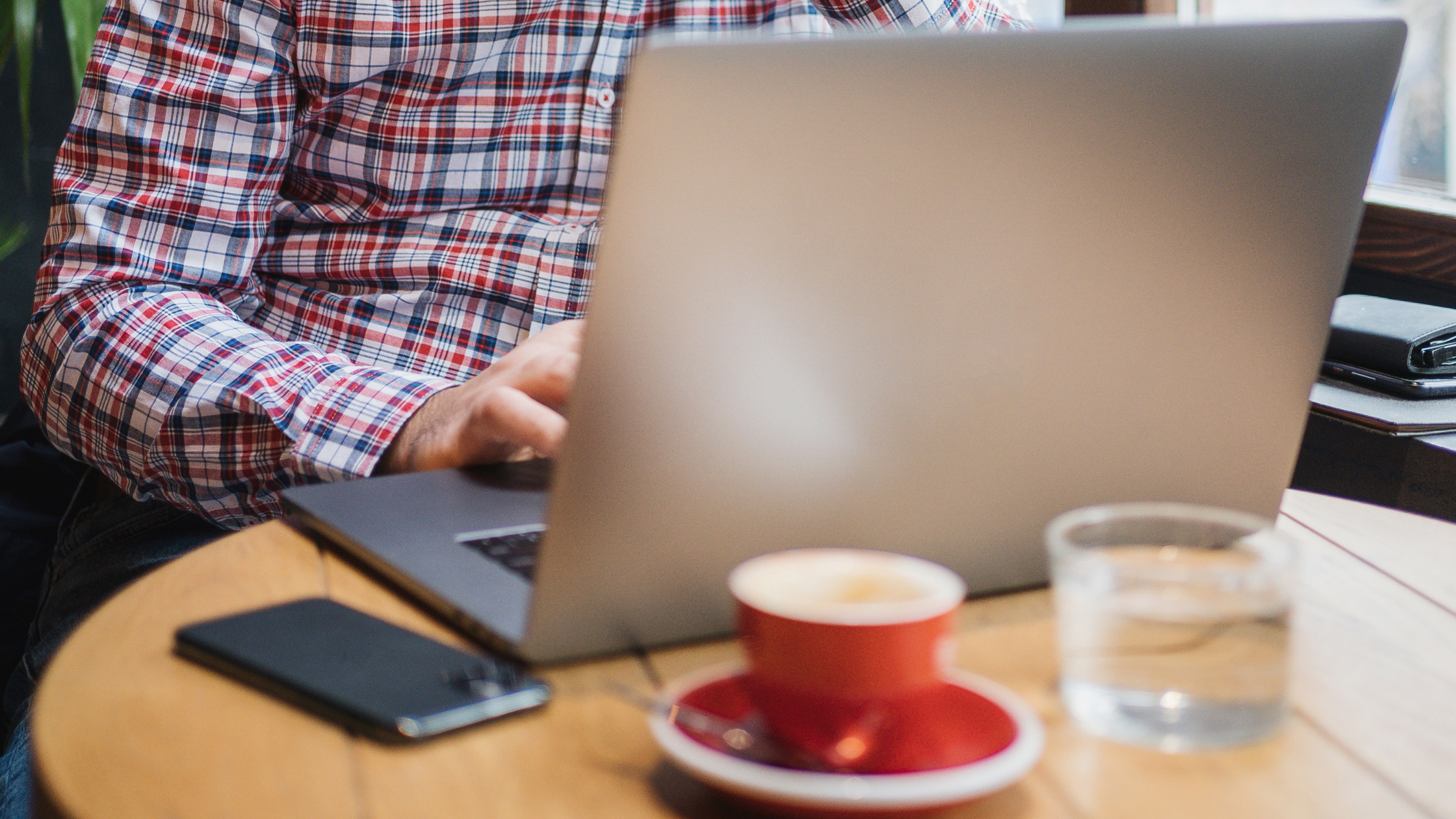 Small business owner reviewing their website on a laptop considering a website redesign